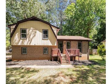 Charming two-story house with brick and siding, complemented by a cozy, wooden front porch at 240 Wellington Dr, Mcdonough, GA 30252