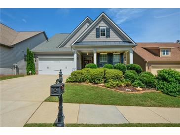 Charming single-Gathering home featuring a manicured front lawn, a two-car garage, and a welcoming entryway at 505 Appalachian Woods Dr, Canton, GA 30114