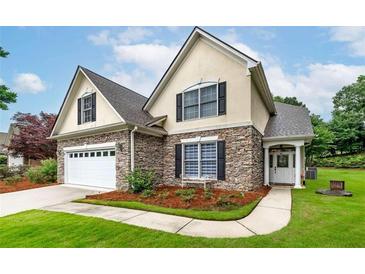 Charming home with stone accents, black shutters, manicured lawn, and inviting front entrance at 1000 Collingtree Ct, Mcdonough, GA 30253