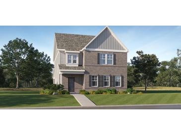 Two-story brick home featuring a well-manicured lawn and tasteful landscaping creating an inviting curb appeal at 317 Fraley Dr, Woodstock, GA 30188
