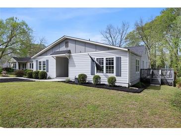 Charming single-story home with gray siding, dark shutters, well-manicured landscaping, and inviting entrance at 1251 Pierce Ave, Smyrna, GA 30080