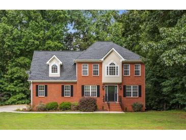 Beautiful red brick two-story home with black shutters and a well-manicured lawn at 4137 Donna Ct, Ellenwood, GA 30294
