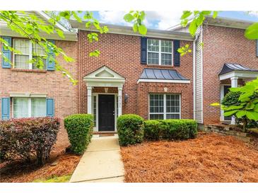 Charming brick townhome with black shutters and a well-maintained front yard at 3737 Town Square Nw Cir # 6, Kennesaw, GA 30144