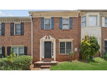 Charming brick townhome with a well-maintained front lawn and inviting entrance at 573 Hambrick Sq, Stone Mountain, GA 30083