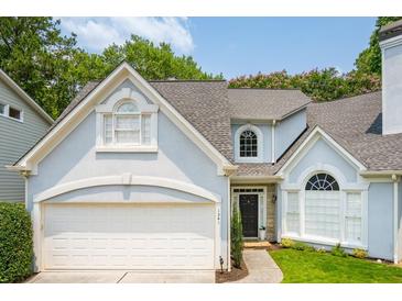Charming two-story home with attached garage, a manicured lawn, and beautiful architectural detailing at 1241 Newbridge Trce, Brookhaven, GA 30319