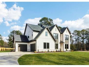 Charming two-story home with a three-car garage and well-manicured lawn at 3735 Tamiami Trl, Cumming, GA 30041