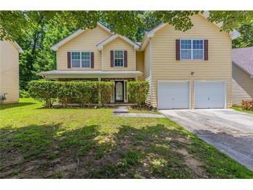 Charming two-story home with a well-maintained lawn and a two-car garage at 260 Redding Rdg, Atlanta, GA 30349