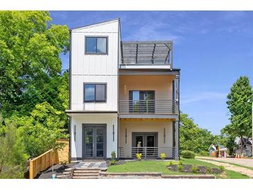 Stunning modern home with three stories and beautiful balconies and clean, neutral colors at 941 Garibaldi Sw St, Atlanta, GA 30310