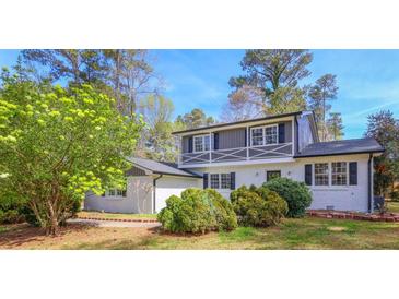 Charming two-story home featuring a brick facade, black shutters and a landscaped front yard at 1749 Lauranceae Way, Riverdale, GA 30296