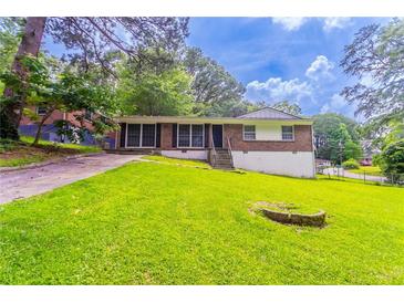 Charming brick home with a lush green lawn, offering a welcoming curb appeal at 4337 Brookside Dr, Forest Park, GA 30297