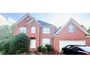 Lovely two-story brick home with well-maintained landscaping and an attached two-car garage at 350 Glynnshire Ct, Covington, GA 30016