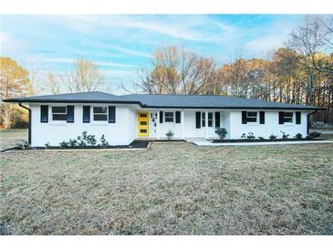 Charming home featuring a freshly painted exterior, complemented by a vibrant yellow front door at 144 Morning Creek Rd, Jonesboro, GA 30238