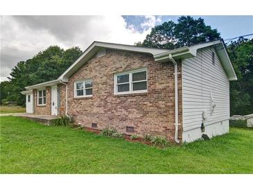 Charming brick home with white trim, surrounded by a lush green lawn and mature trees at 24 Echo Ridge Dr, Powder Springs, GA 30127