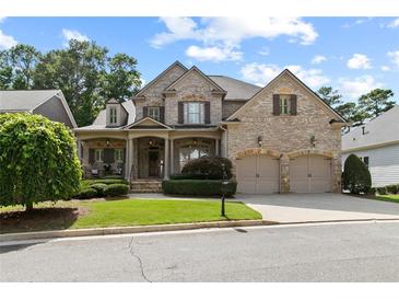 Charming brick home featuring a manicured front yard and a welcoming two-car garage at 1701 Tipton Nw Ct, Acworth, GA 30101