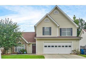 Charming two-story home featuring a two-car garage and well-maintained lawn at 375 Shadetree Ln, Lawrenceville, GA 30044