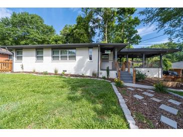 Charming home featuring a well-manicured front yard and stylish walkway to the front porch at 1261 Calhoun Sw Ter, Atlanta, GA 30314