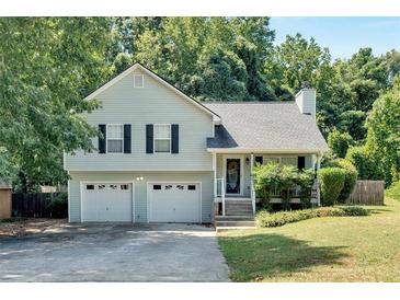 Charming two-story home with a well-maintained lawn, two-car garage, and traditional architectural details at 127 Muirwood Dr, Temple, GA 30179