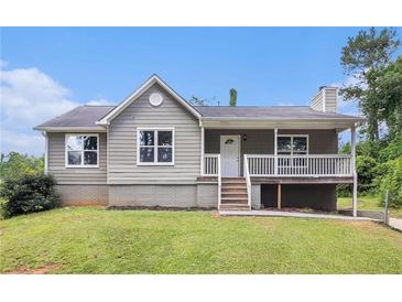 Charming home featuring a gray exterior, front porch, and well-maintained lawn at 28 Fawn Ct, Sharpsburg, GA 30277