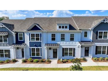 Charming new construction townhomes featuring brick facades, well-manicured lawns, and inviting entryways at 2472 Honey Way, Conyers, GA 30013