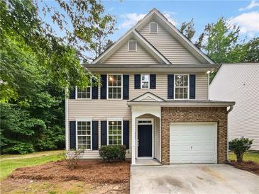 Charming two-story home with brick accents, a well-manicured lawn, and a welcoming front entrance at 6240 Shenfield Ln, Union City, GA 30291