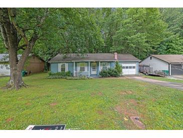 Charming single-story home with light blue siding and a well-maintained front yard at 5012 Galbraith Cir, Stone Mountain, GA 30088