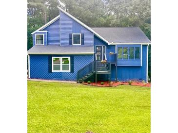 Charming blue two-story home with well-maintained lawn and inviting front entrance at 3706 Londonderry Ct, Lithonia, GA 30038
