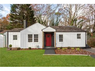 Charming one-story home with white siding, a red front door, and a well-manicured lawn at 1349 Lockhaven Sw Cir, Atlanta, GA 30311