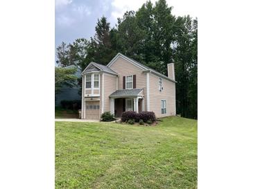 Charming two-story home with a manicured lawn and attached garage at 5030 N Bridges Dr, Alpharetta, GA 30022