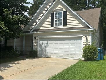 Charming home with a two-car garage and mature landscaping at 76 Daisy Meadow Trl, Lawrenceville, GA 30044
