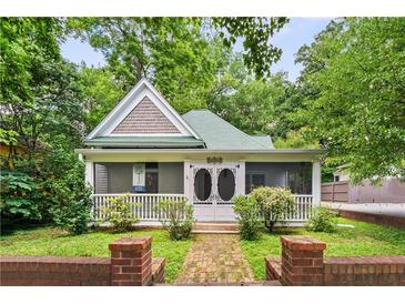 Charming home featuring a picturesque front porch and lush landscaping at 240 Melrose Ave, Decatur, GA 30030