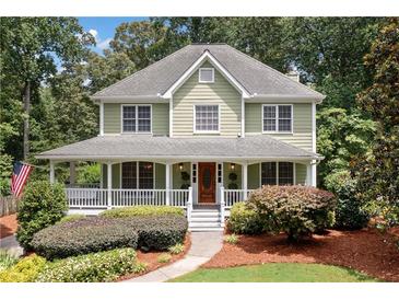 Charming two-story home with a welcoming front porch and beautifully landscaped front yard at 526 Summer Ter, Woodstock, GA 30189