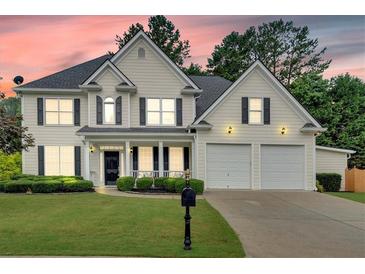 Charming two-story home featuring a well-manicured lawn, two-car garage, and classic black shutters at 3957 Marquette Nw Way, Kennesaw, GA 30144