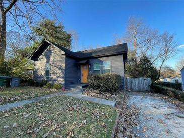 Charming home featuring a well-maintained lawn and a welcoming, bright yellow front door at 535 Walnut St, Hapeville, GA 30354