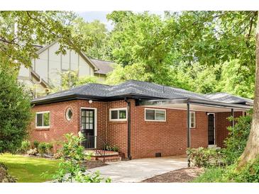 Charming brick home with a covered carport and well-manicured landscaping at 138 Woodlawn Ave, Decatur, GA 30030