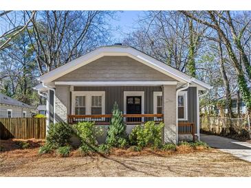 Charming craftsman-style home with a gray exterior, quaint front porch, and well-maintained landscaping at 1045 Moreland Se Ave, Atlanta, GA 30316