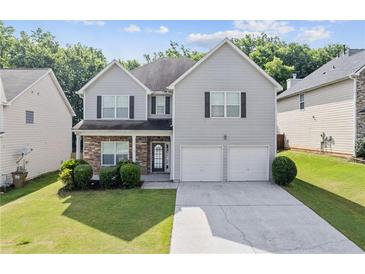 Charming two-story home with stone accents, well-maintained lawn, and a two-car garage at 4420 Ambassador Way, Cumming, GA 30040