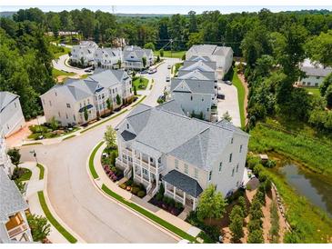 Community aerial view showcases craftsman townhomes, landscaped yards, and a tranquil water feature at 2125 Parkside Ln, Roswell, GA 30076