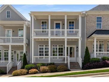 Charming two-story home with a double porch, complemented by manicured landscaping and sidewalk appeal at 2125 Parkside Ln, Roswell, GA 30076