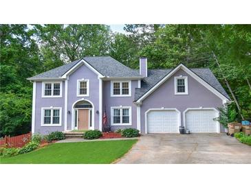 Charming two-story home boasts a well-manicured lawn, inviting entrance, and a convenient two-car garage at 5028 Jamie Ne Ct, Woodstock, GA 30188