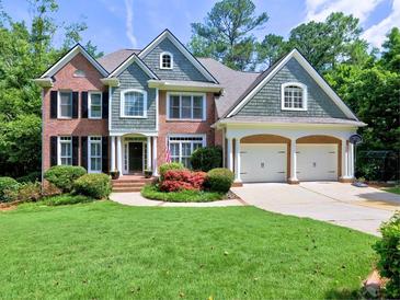 Charming two-story brick home with a well-manicured lawn and a two-car garage at 658 Vinings Estates Se Dr, Mableton, GA 30126