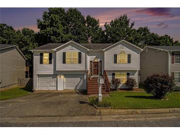 Charming split-level home with a well-maintained lawn, inviting stairs, and an attached two-car garage at 3372 Springside Rdg, Decatur, GA 30034