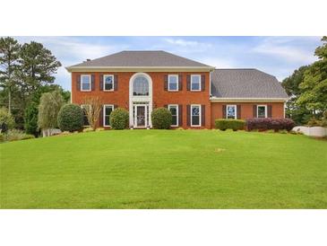 Charming two-story brick home with a large front yard and mature landscaping, perfect for families or those who enjoy outdoor space at 1197 Kenilworth Trce Trce, Snellville, GA 30078
