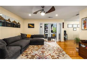 Inviting living room featuring hardwood floors, a ceiling fan, and a comfortable grey sectional sofa at 1445 Monroe Ne Dr # 14B, Atlanta, GA 30324