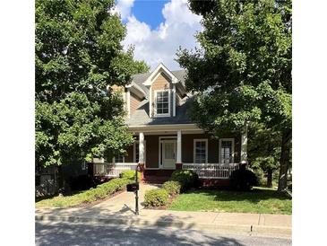 Charming two-story home with a cozy front porch and well-maintained landscaping, nestled among mature trees at 2165 Parkview Nw Run, Atlanta, GA 30318