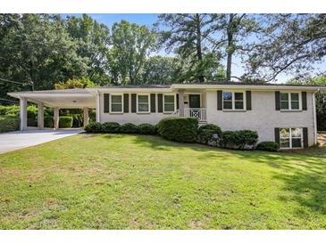 Charming brick ranch-style home with manicured lawn and covered carport at 2855 Briarlake Ne Rd, Atlanta, GA 30345