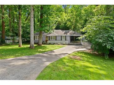 Charming single-story home with a long driveway, mature trees, and a well-maintained lawn at 269 Terrydale Se Dr, Marietta, GA 30067