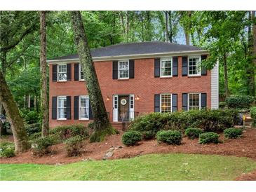 Charming brick home with black shutters and a beautifully landscaped front yard at 1209 Colony Cir, Marietta, GA 30068