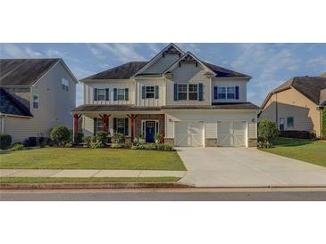 Charming two-story home features a welcoming front porch, attached two car garage, and manicured front lawn at 110 Ashbury Circle Cir, Dallas, GA 30157