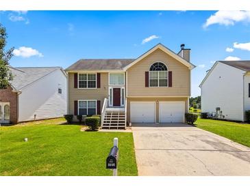 Charming two-story home with a well-maintained lawn and a two-car garage at 11833 Spring Lake Way, Fayetteville, GA 30215