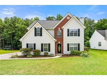 Charming two-story home with a landscaped yard and brick accents at 2479 Heatherton Ct, Dacula, GA 30019